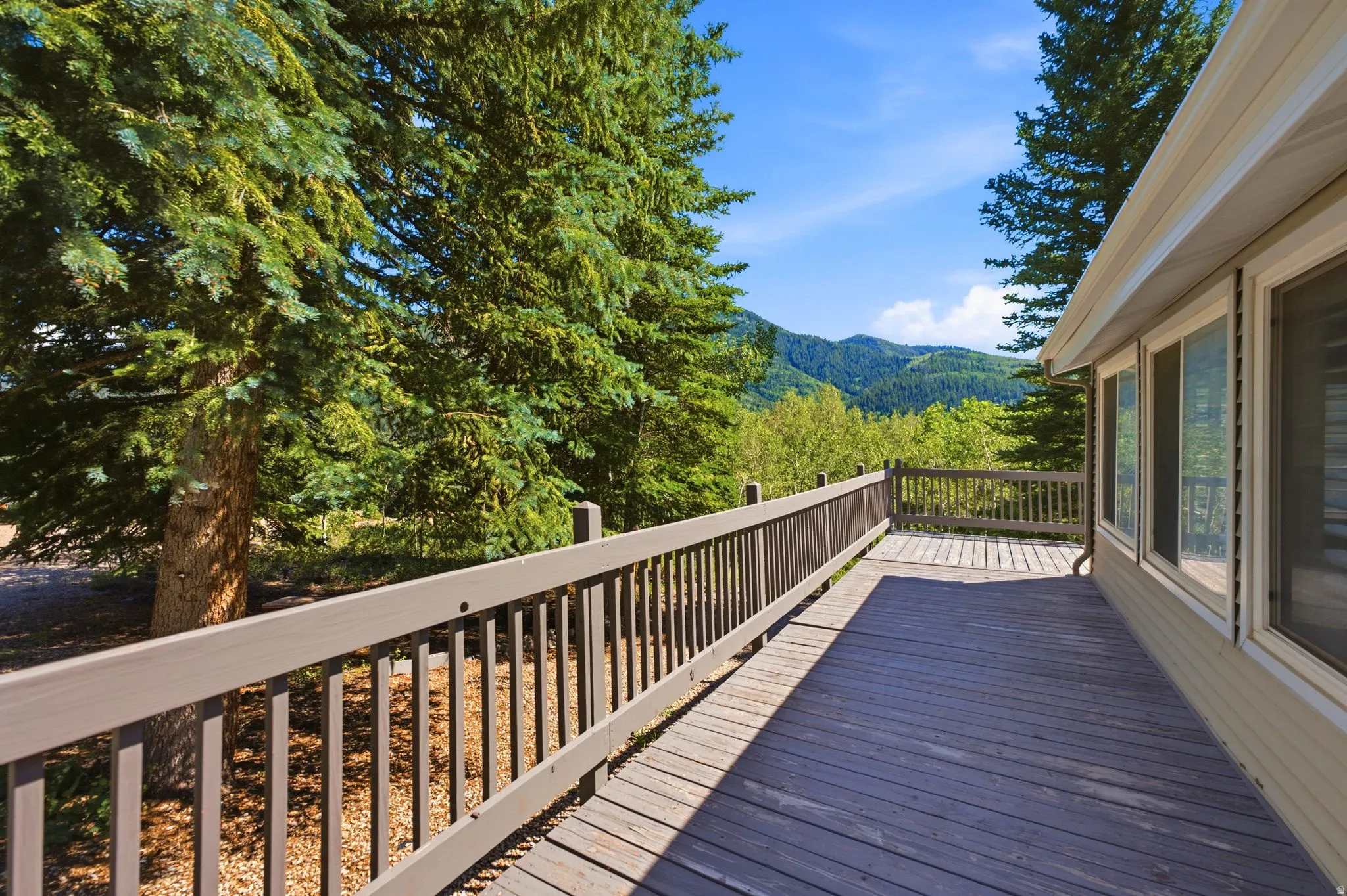 Expansive outdoor wooden deck with a matching railing system