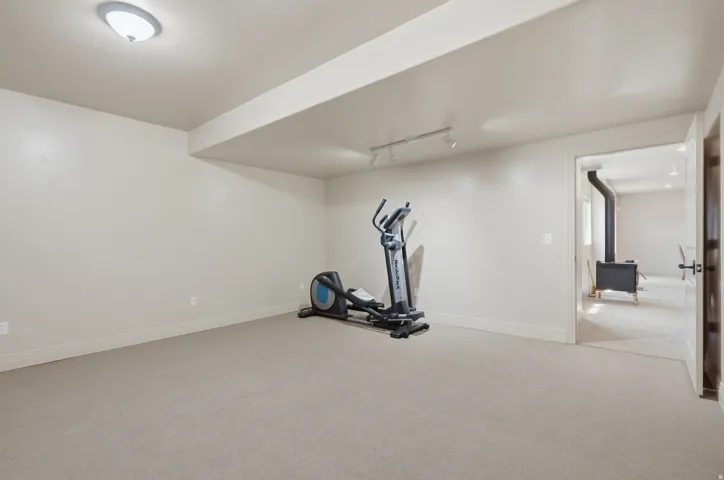 Spacious carpeted room with neutral paint, recessed lighting, and a wide entryway