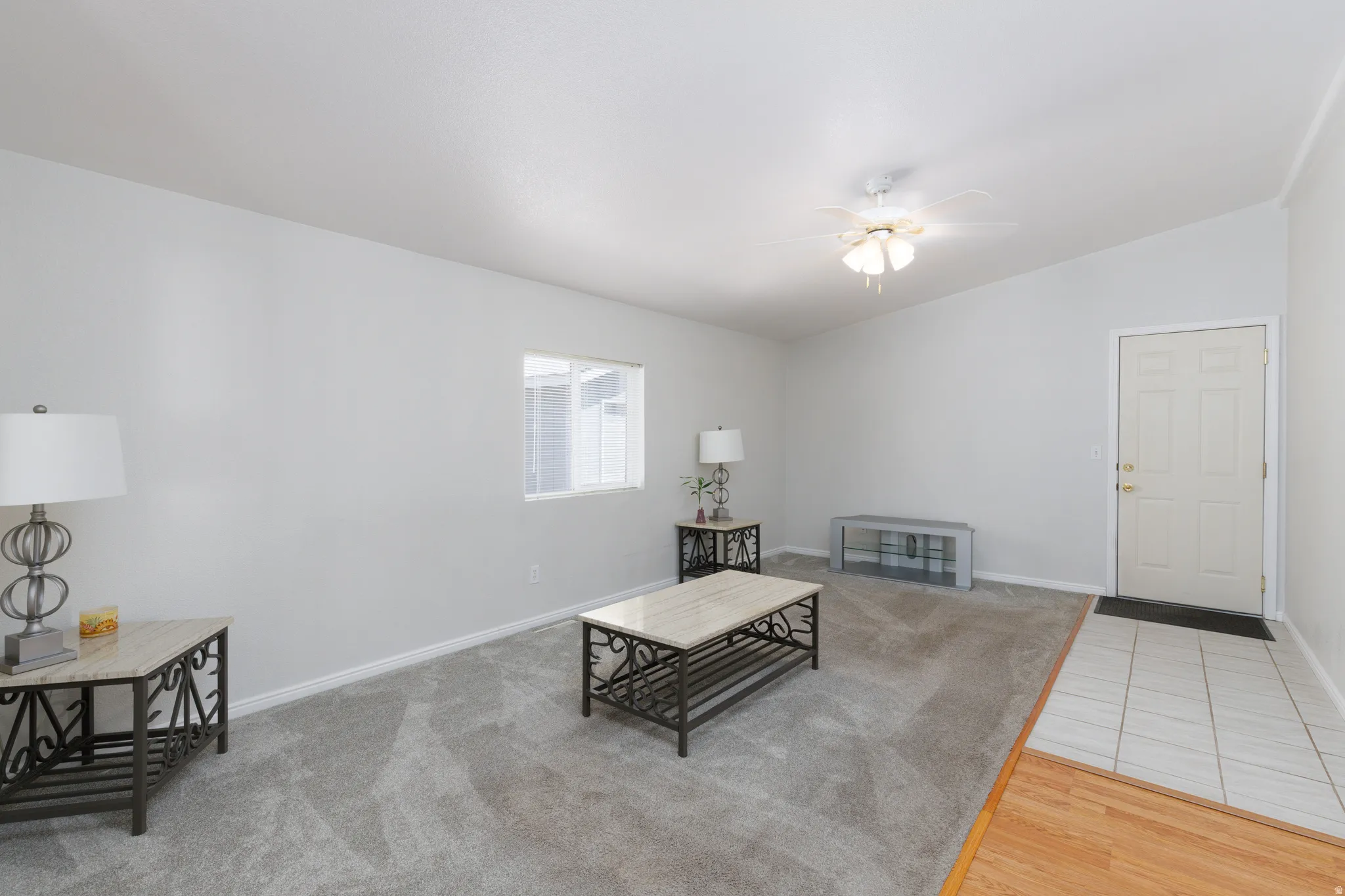 Living area featuring light gray wall paint and gray carpet flooring