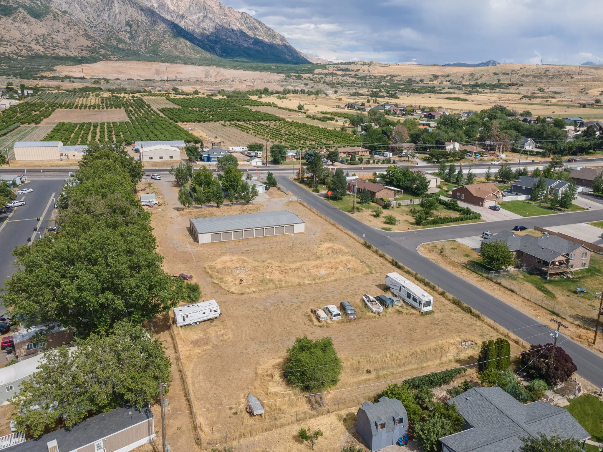Expansive undeveloped land parcel featuring a large storage building