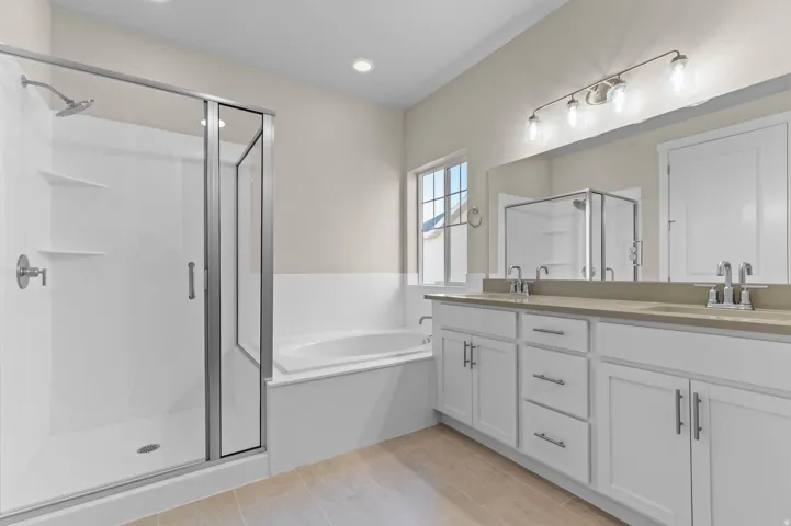 Contemporary bathroom featuring a glass-enclosed shower, a built-in soaking tub, and a double vanity with two undermount sinks