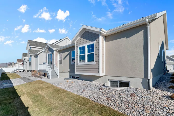 Contemporary exterior with a stucco and siding combination, white trim, and multiple windows