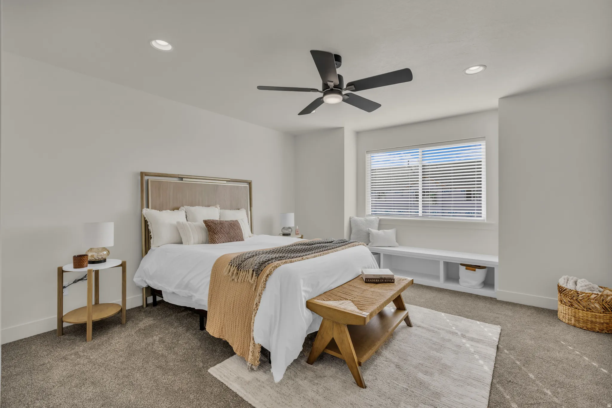 Spacious bedroom featuring neutral wall tones, recessed lighting, and a contemporary ceiling fan