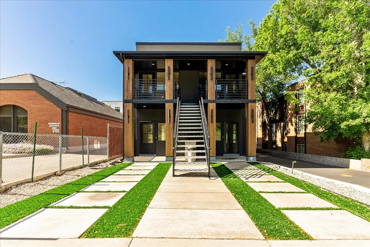 Modern facade featuring wood-clad pillars and dark exterior siding
