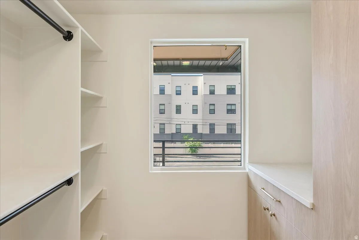 Custom closet featuring integrated shelving and hanging rods