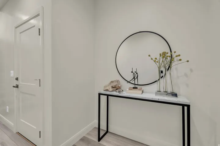 Entryway featuring a solid panel door with contemporary hardware