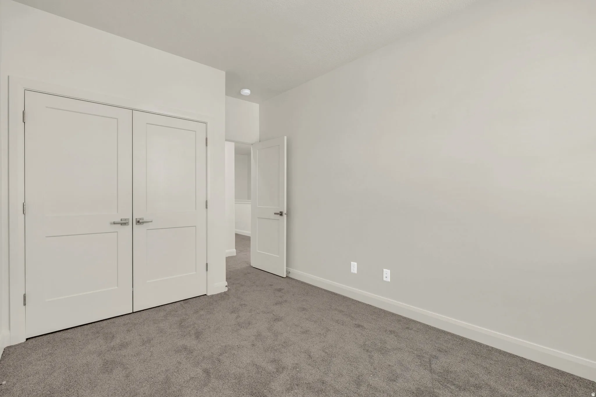 Neutral wall tones and gray carpeting