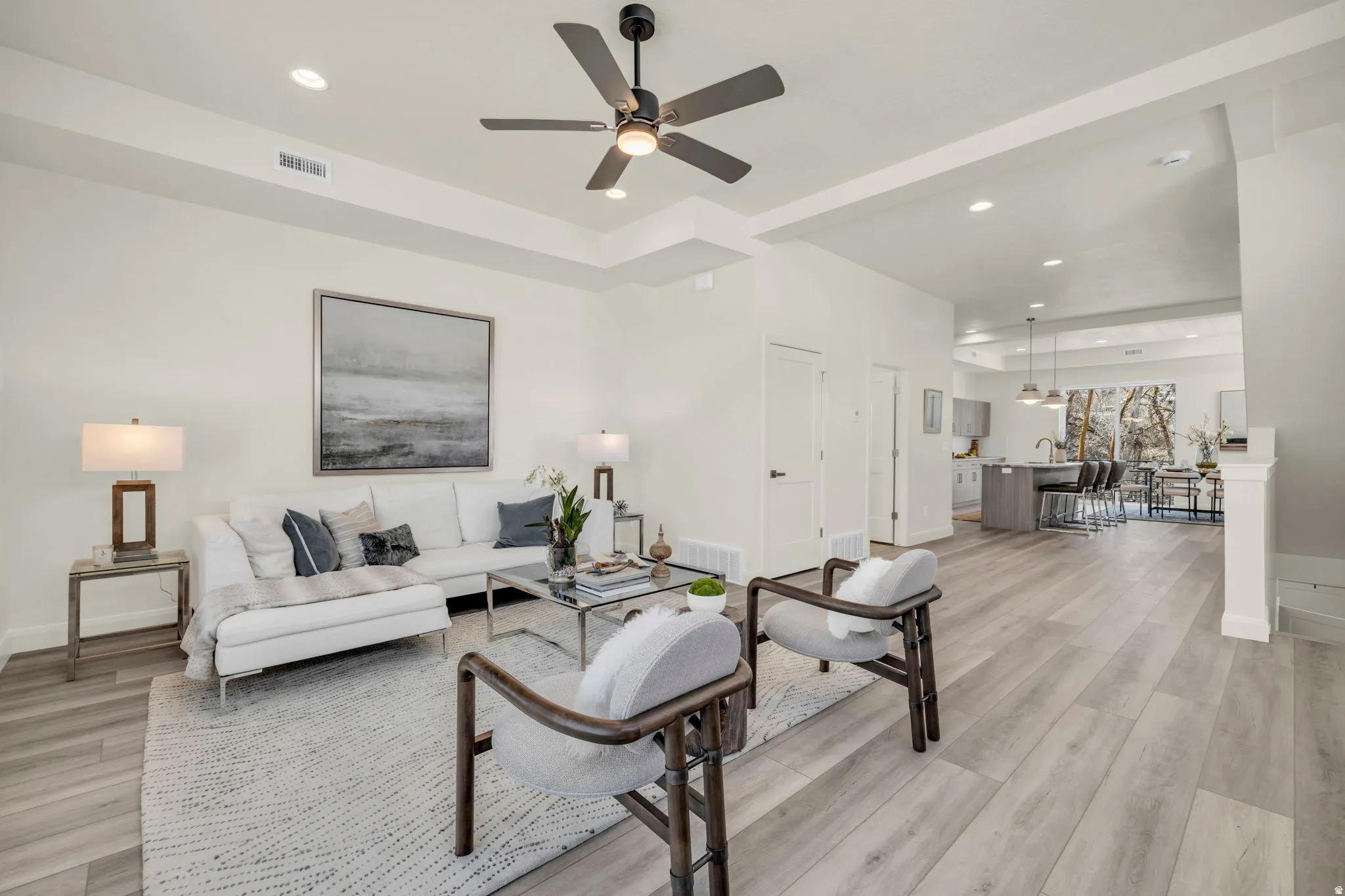 Spacious living area featuring wood-finish flooring, recessed lighting, and a modern ceiling fan