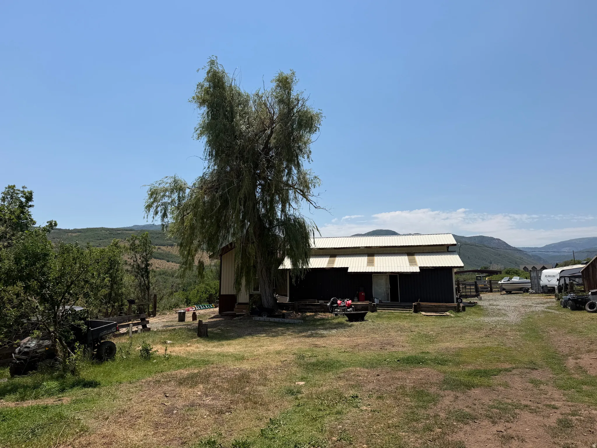 Metal-sided outbuilding with a white corrugated metal roof