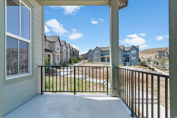 Balcony with concrete flooring and black metal railing