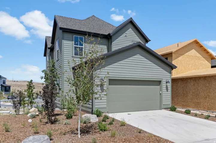 Contemporary two-story residence featuring sage green horizontal siding and a dark shingle roof