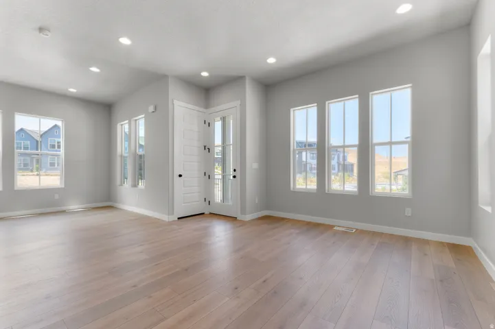 Open concept living area with wood-finish flooring
