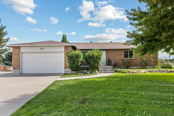 Brick exterior with an attached garage and concrete driveway