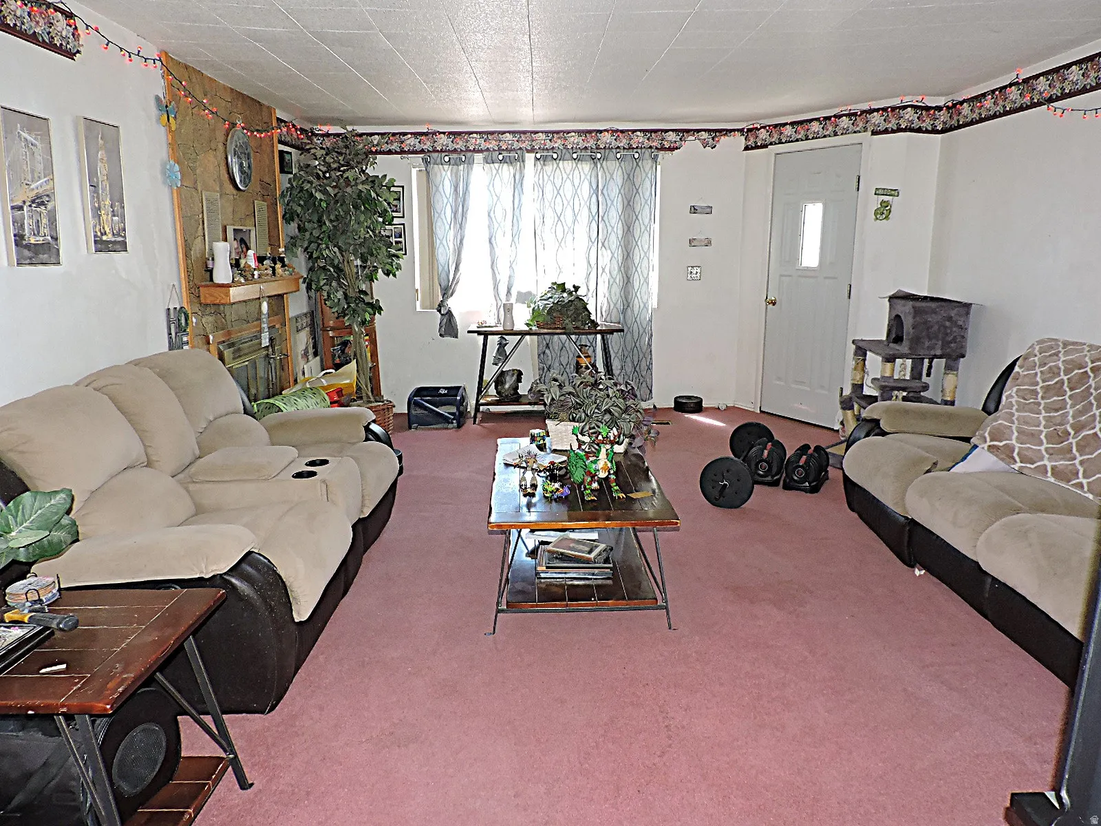 Living area featuring pink carpeting and white walls