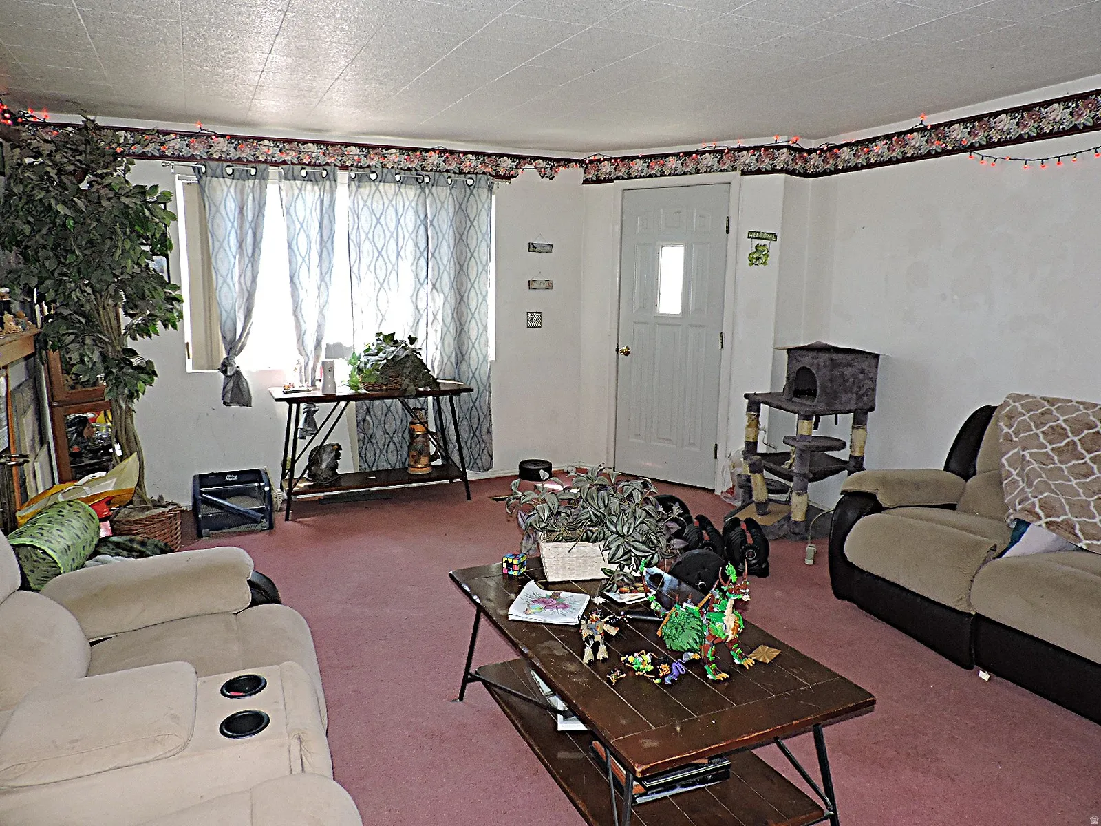 Carpeted interior space featuring white walls
