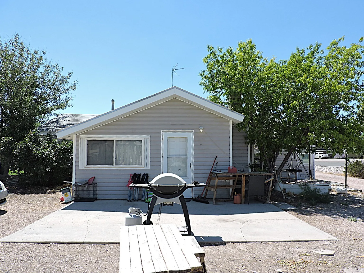 Single-story residence featuring light gray siding and a white trim