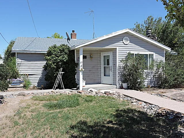 Ranch-style residence featuring horizontal siding, a covered entry porch, and a pitched shingle roof
