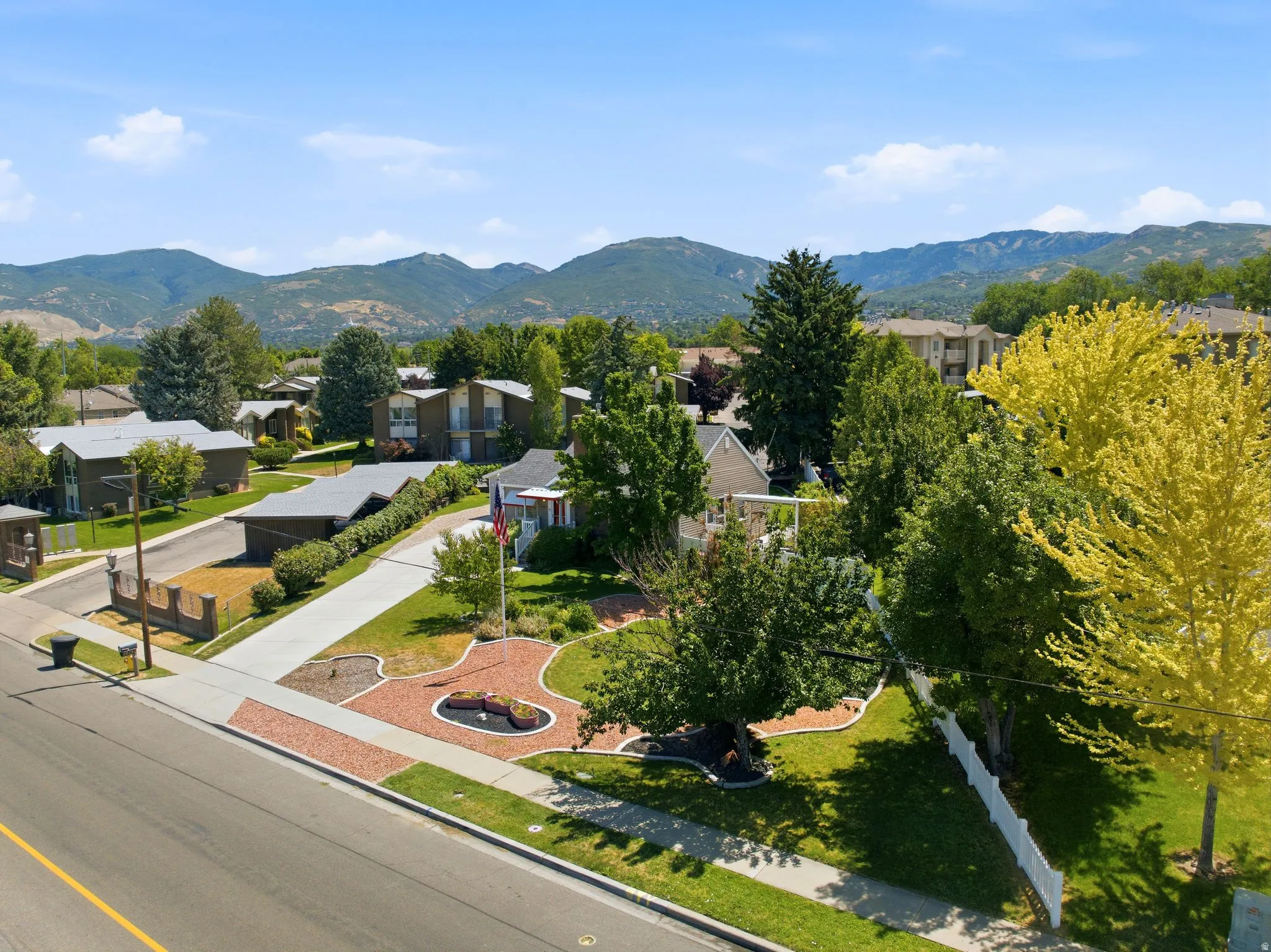 Expansive landscaping featuring mature trees and a manicured lawn