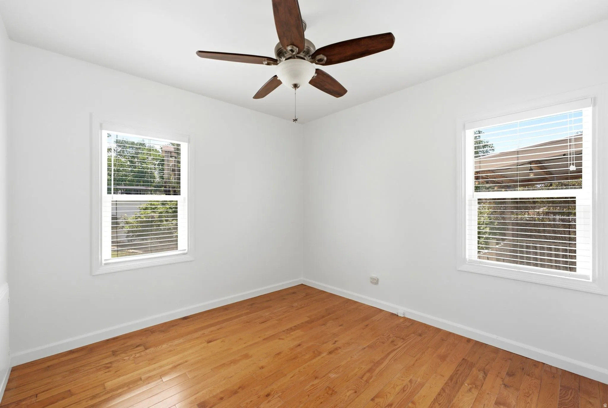 Interior space featuring wood-finish flooring and white baseboards