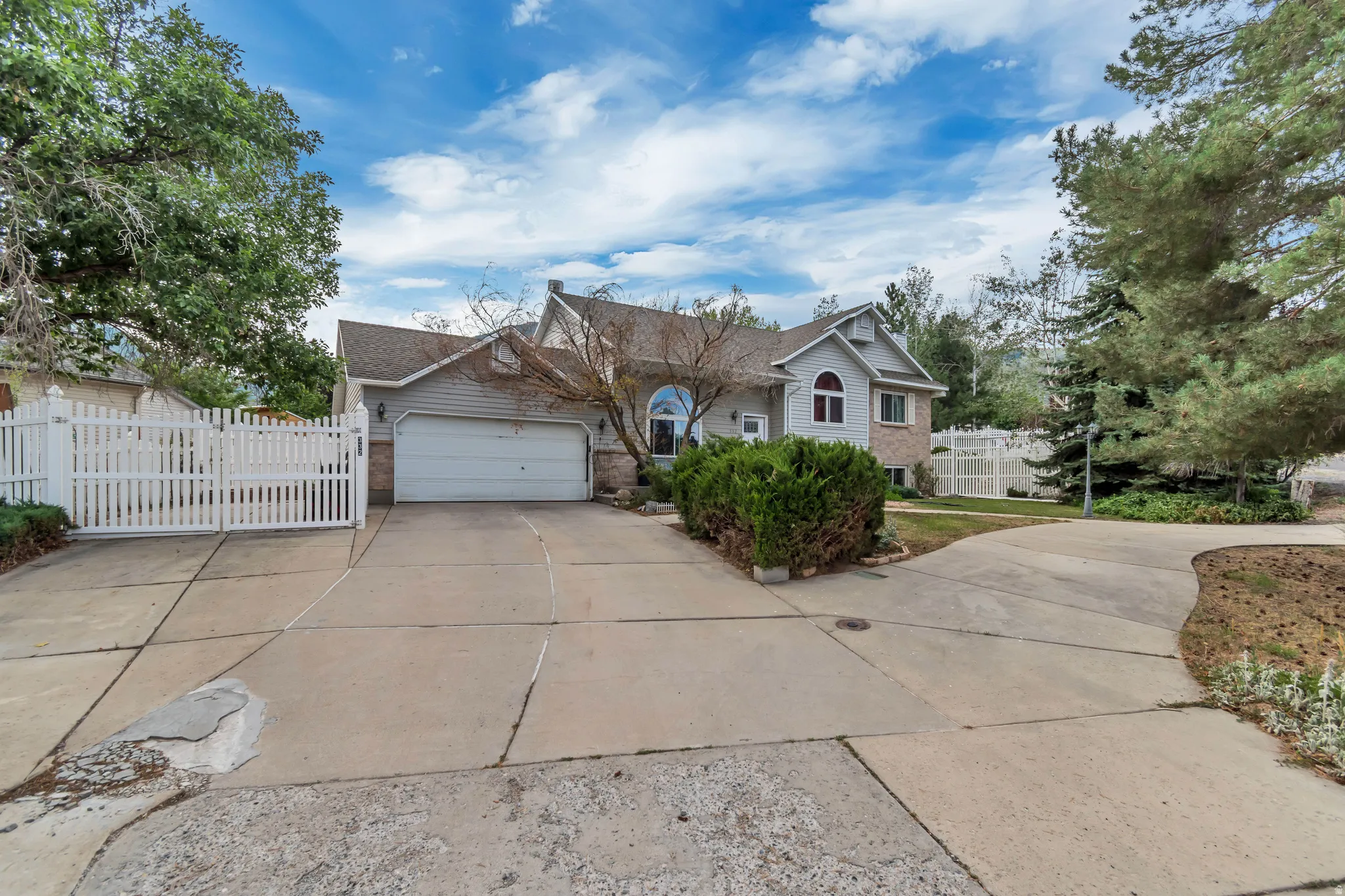 Traditional-style residence featuring a two-car garage with overhead door