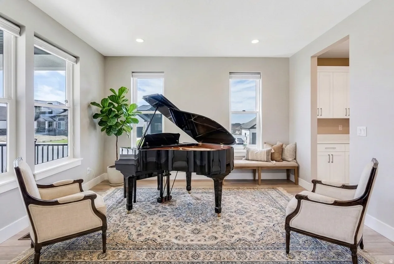 Virtual Staging. Bright interior space featuring recessed lighting, light wood-finish flooring, and multiple large windows with white trim