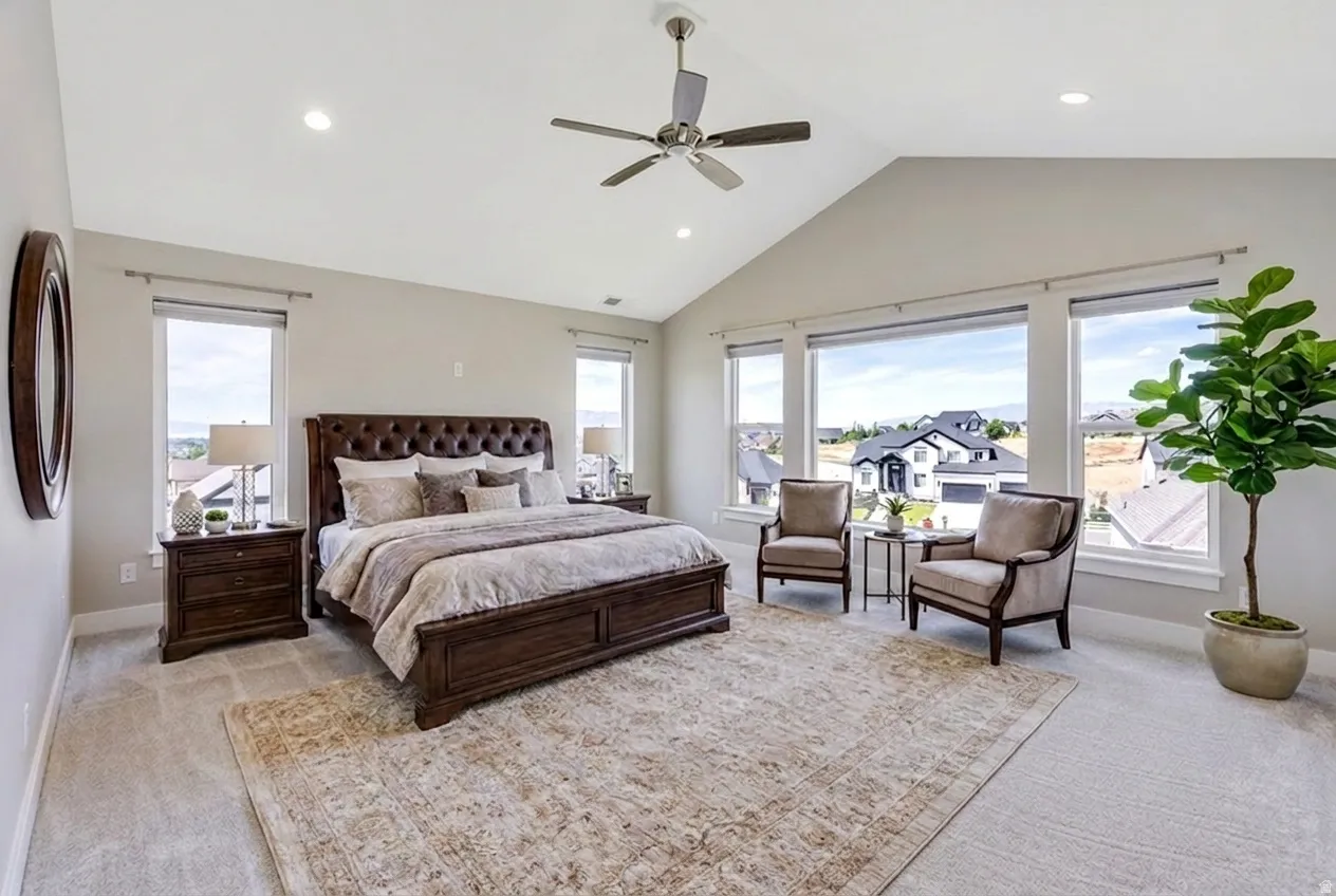 Virtual Staging. Vaulted primary room with a ceiling fan, recessed lighting, and expansive windows