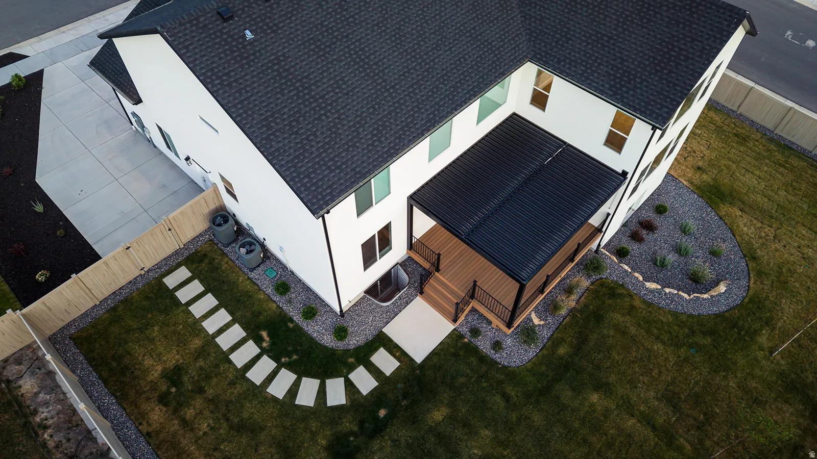 Modern white exterior with dark roof and trim accents