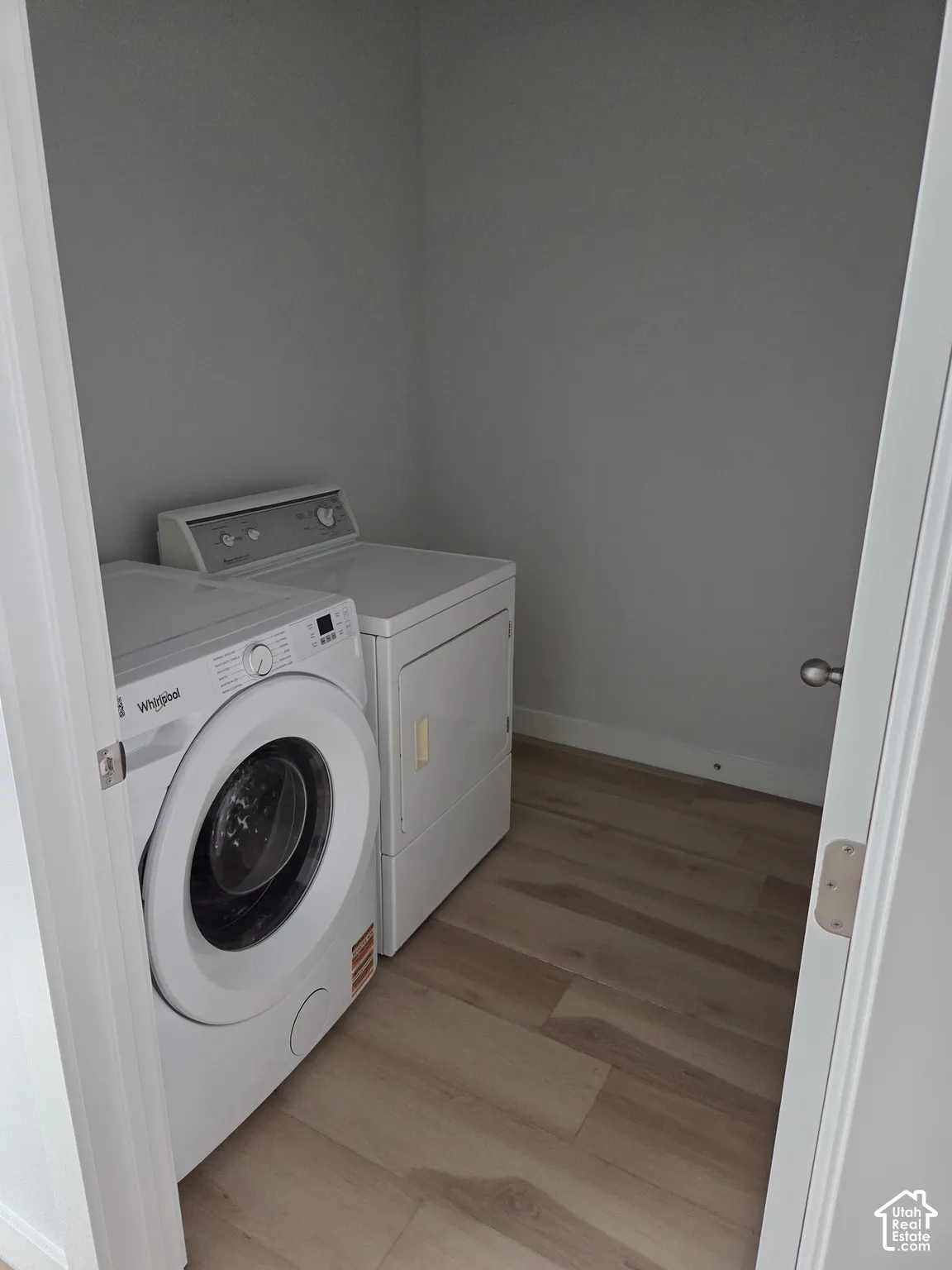 Dedicated laundry alcove featuring stacked appliance capability