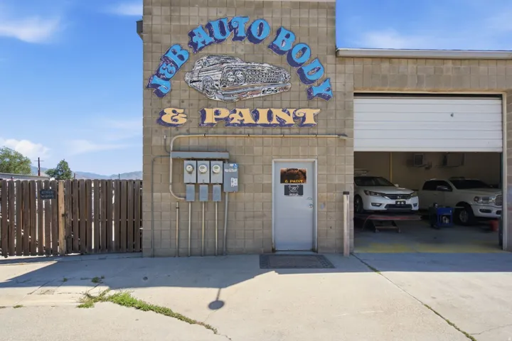 Commercial building with block construction, a large roll-up garage door, and a dedicated entry door
