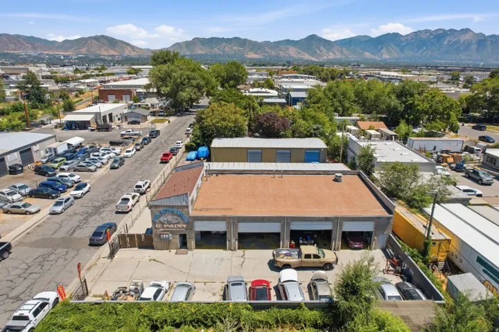 Commercial property featuring a large asphalt lot and multiple garage bays