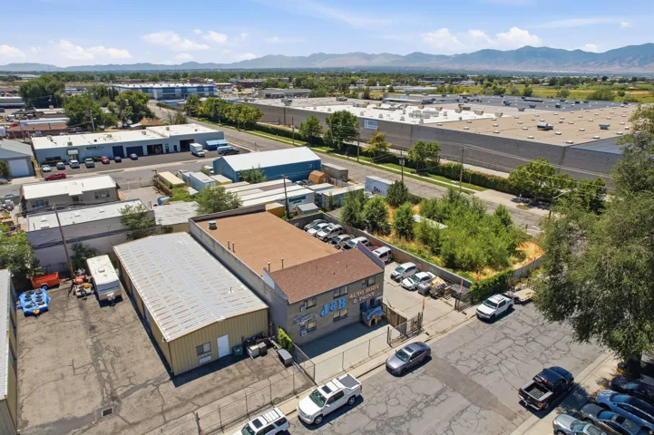 Industrial property featuring two primary buildings with metal roofing and a paved lot