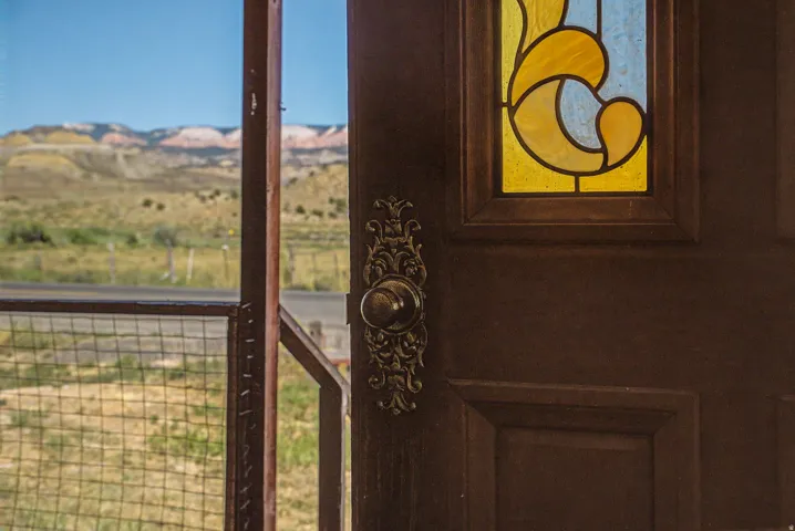 Dark wood entry door with stained glass insert