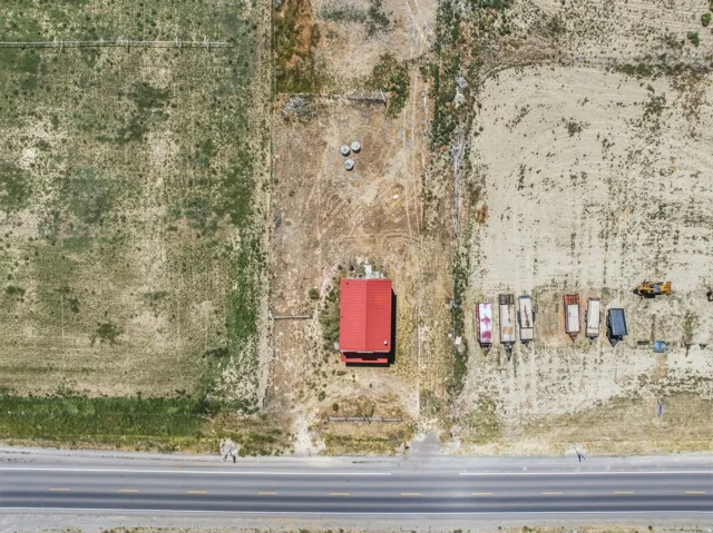 Aerial perspective showcasing a parcel with a red-roofed structure