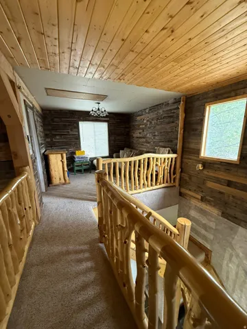 Rustic wood-finish plank ceilings and walls define this interior space