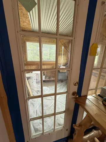 French door with multi-pane glass panels and brass hardware