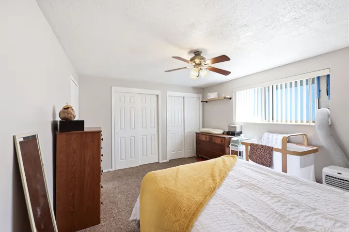 Room featuring neutral wall tones and textured carpet
