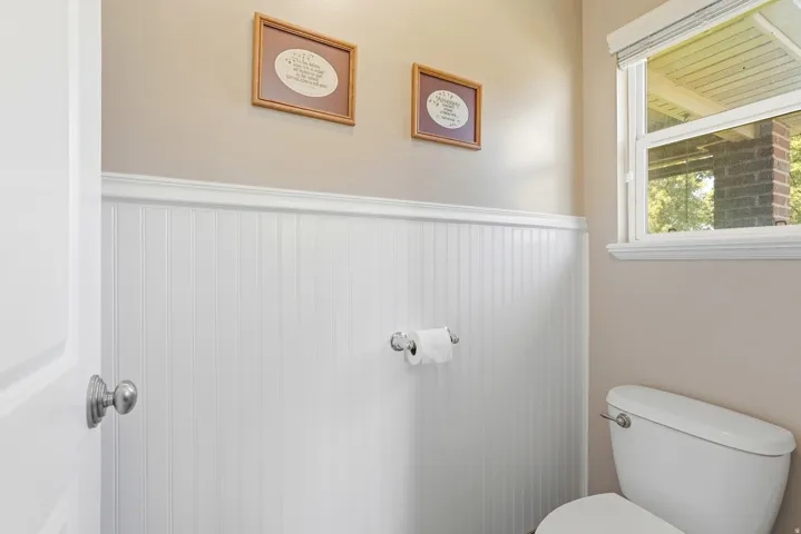 Bathroom featuring white beadboard wainscoting and coordinating trim
