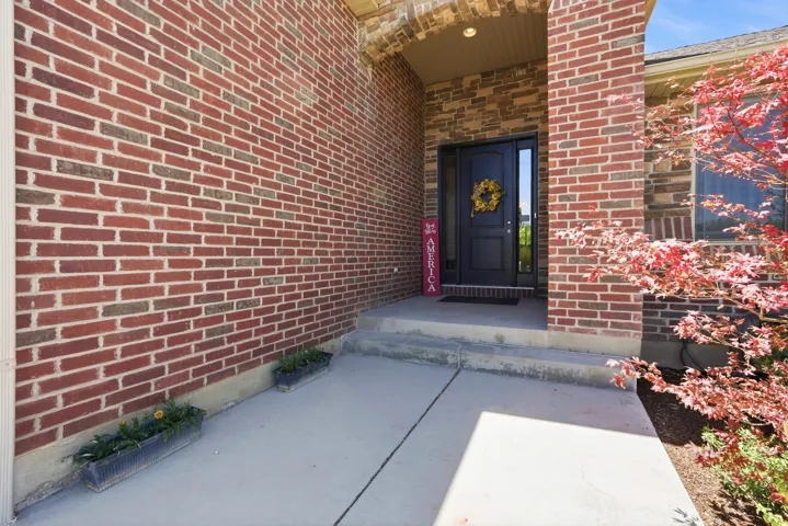 Brick exterior with an arched entryway and a dark-paneled front door