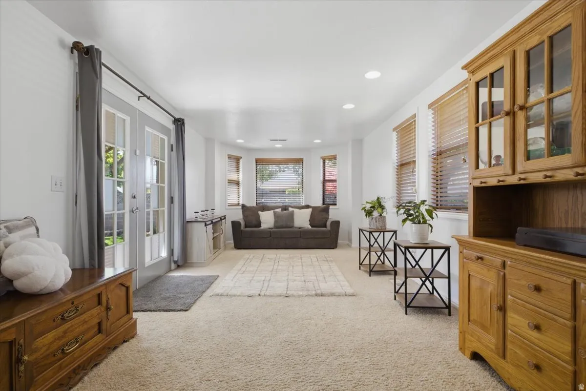 Bright living space featuring plush carpeting throughout