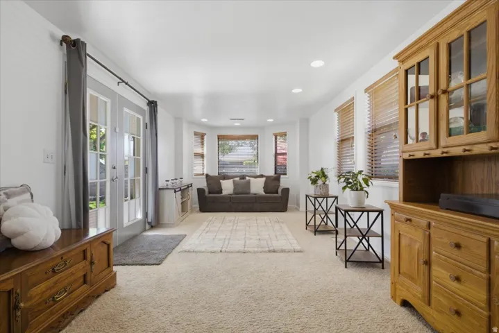 Bright living space featuring plush carpeting throughout