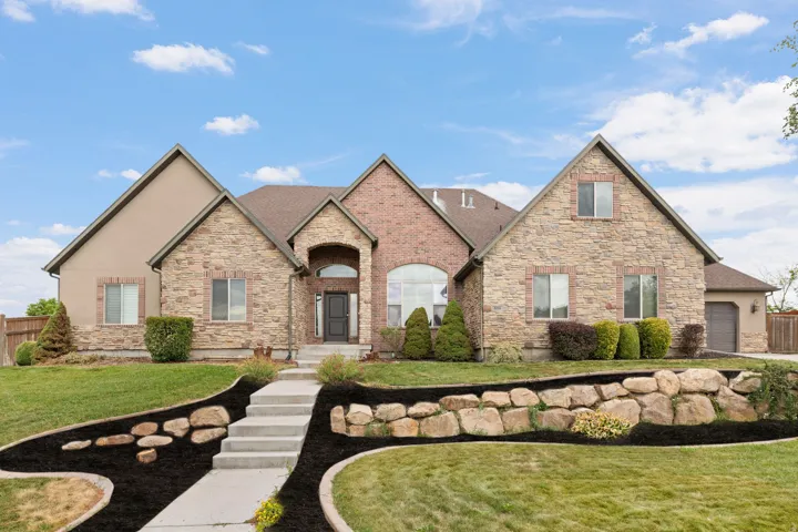 Stone and stucco exterior with a brick archway entry