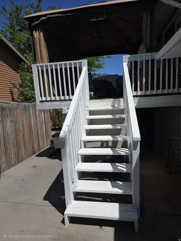 White-painted wooden staircase providing outdoor access