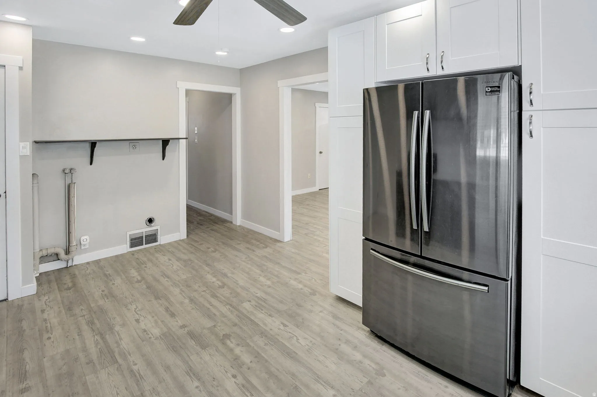 Modern kitchen space featuring a stainless steel French door refrigerator