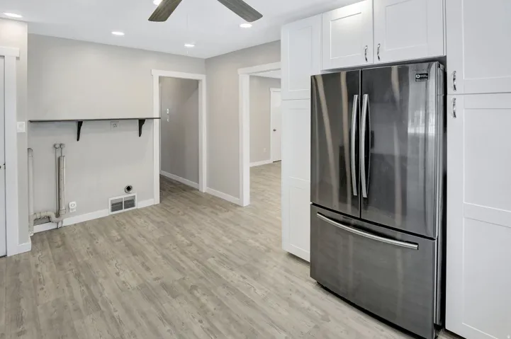 Modern kitchen space featuring a stainless steel French door refrigerator