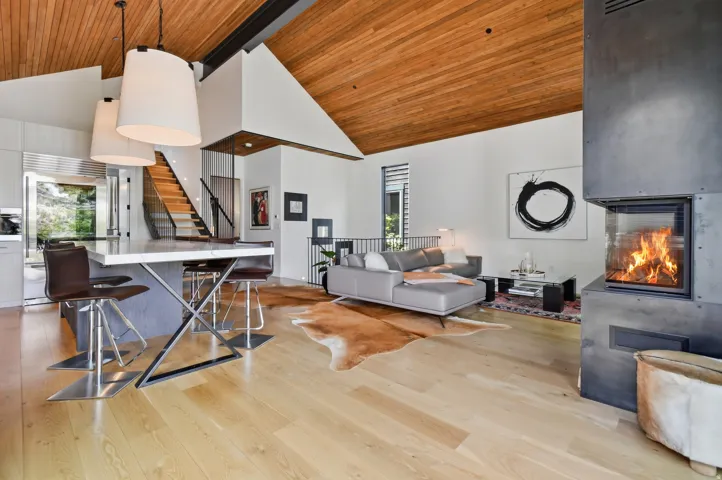 Vaulted wood-paneled ceiling above light wood-finish flooring