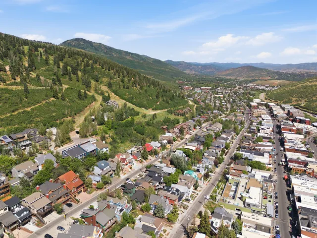 Expansive townscape featuring diverse residential architecture, commercial structures, and a prominent main thoroughfare