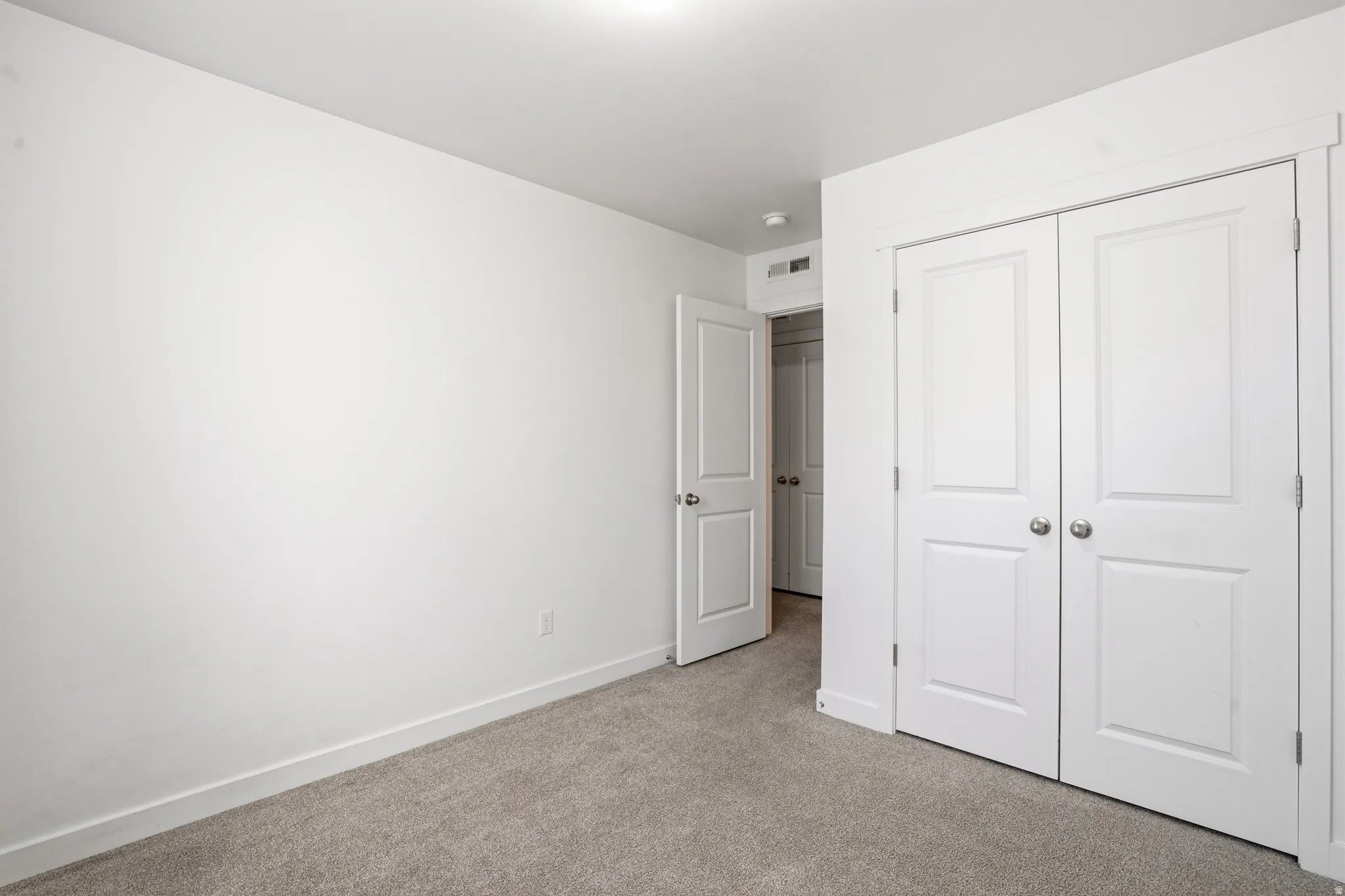 Neutral-toned carpeting paired with white walls