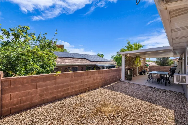 Expansive outdoor area featuring a gravel ground cover and a concrete patio