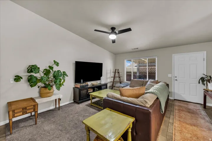 Vaulted ceilings complement the neutral wall paint and textured carpeting