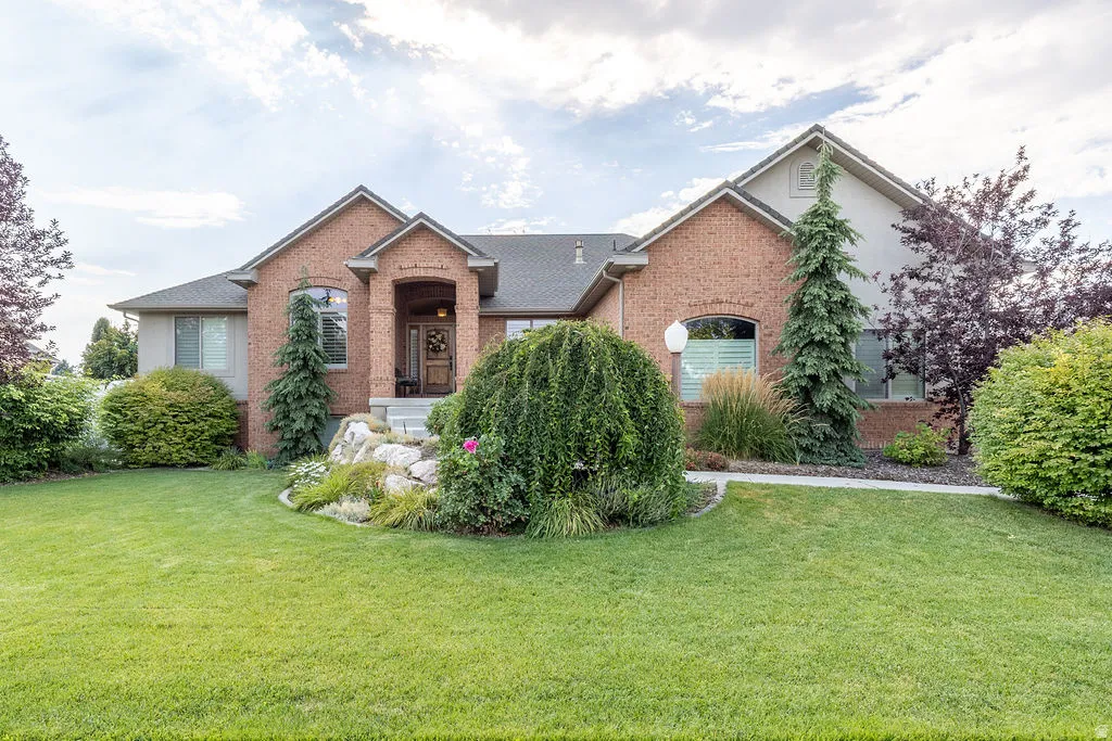 Brick and stucco exterior featuring a covered entry porch